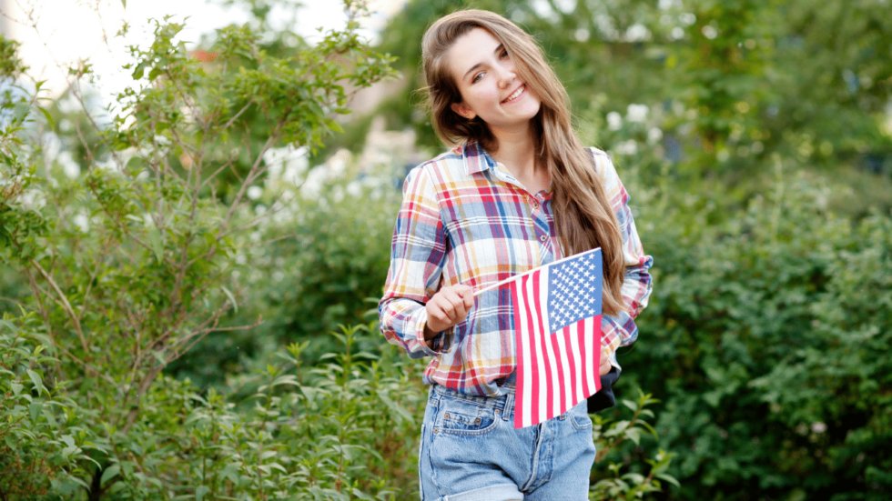 Woman holding a US flag on a stick
