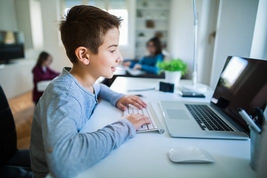 school boy at home with computer