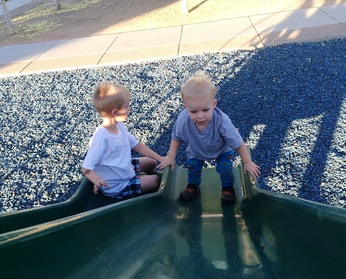 empowering kids on slide at park
