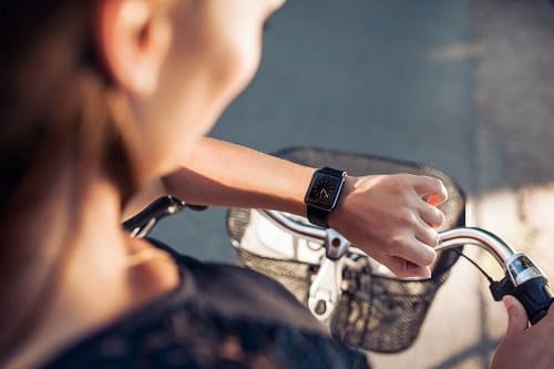 woman on bike with watch
