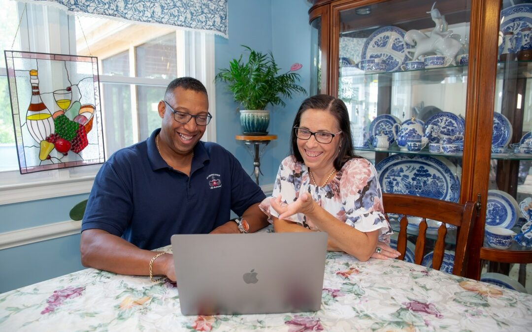 Military Couple looking at a laptop smiling
