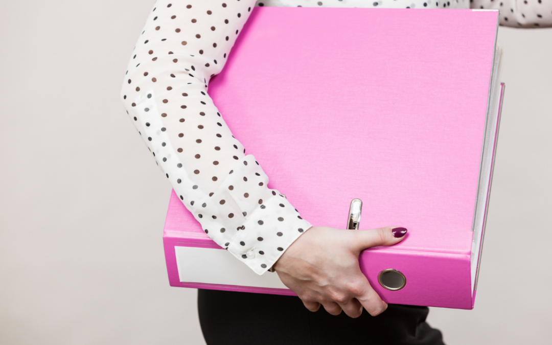 Woman holding a pink Military Family Binder