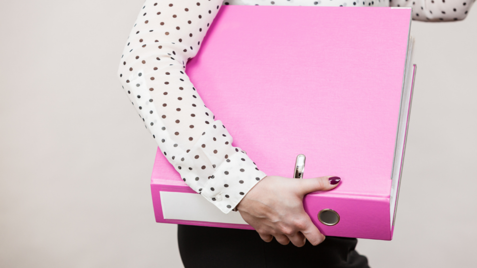 Woman holding a pink Military Family Binder