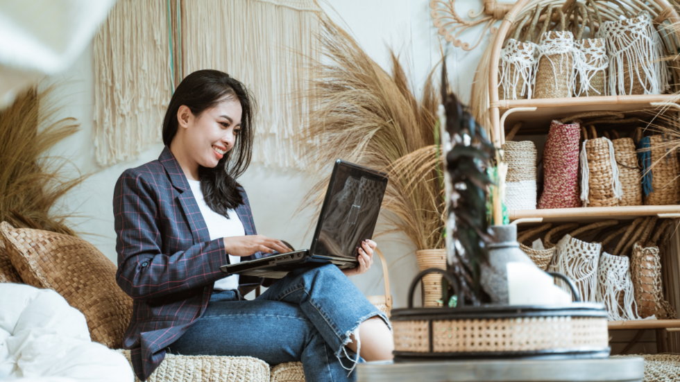 Woman sitting on a chair with a laptop on her lap