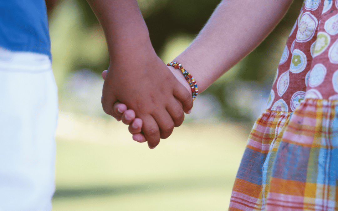 Two children holding hands.