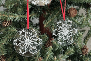 set of three snowflake ornaments where the designed snowflake has fighter jets
